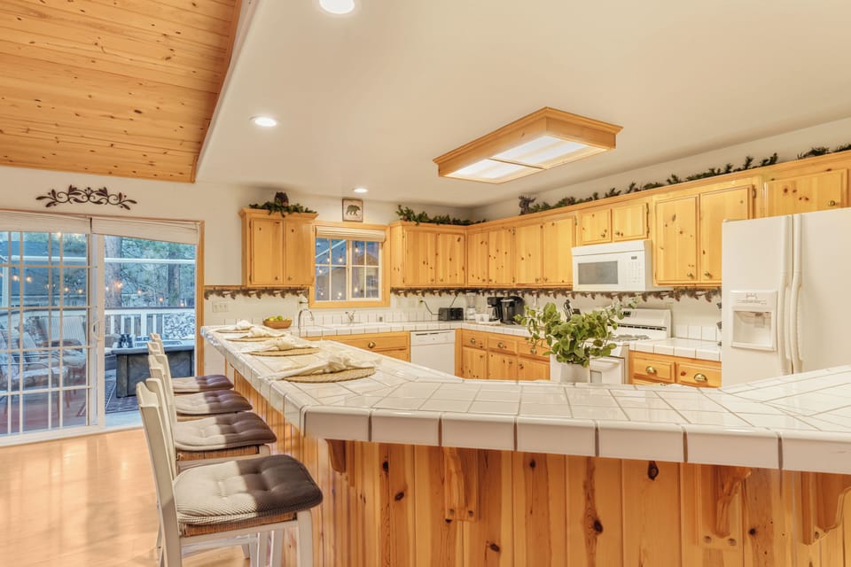 Large kitchen with wraparound breakfast bar seating and plenty of prep space.
