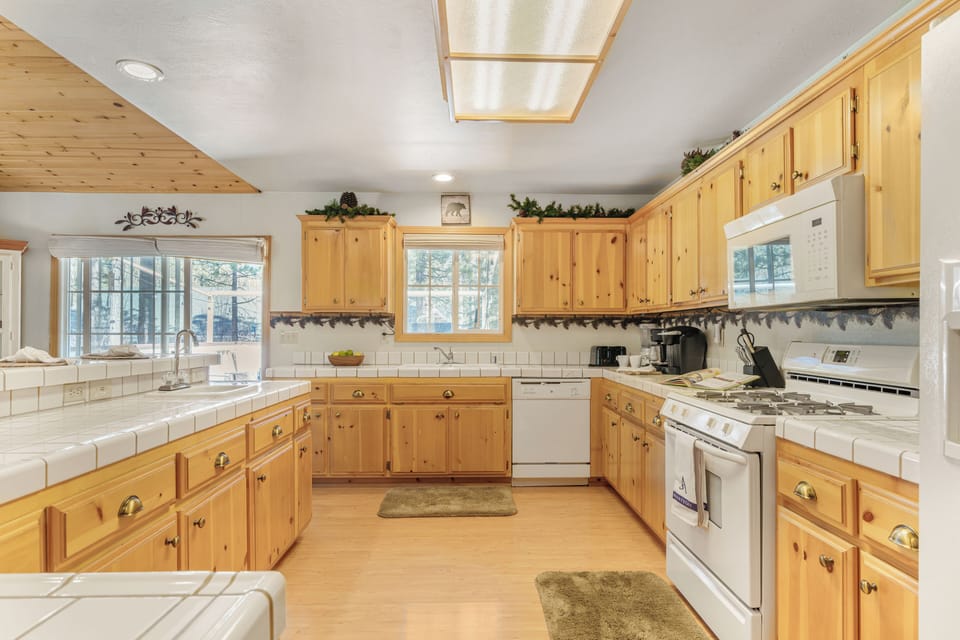 Fully equipped kitchen with ample counter space and bright natural light.