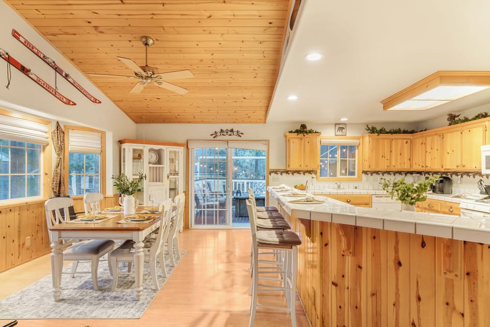 Open kitchen and dining area with bar seating and easy access to the deck.