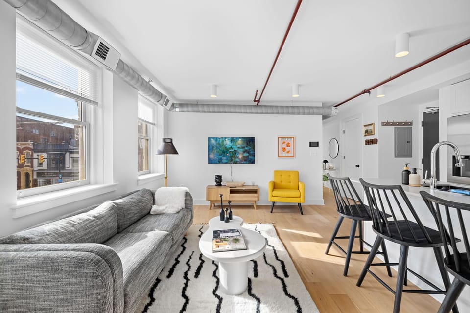Sun-drenched corner living space with bold contemporary art