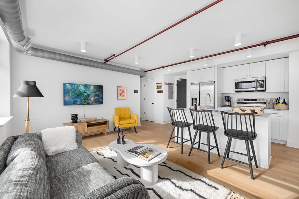 Open-concept layout with exposed industrial ductwork and King Street views