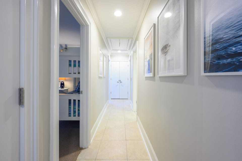 Hallway to Bunk BR on left and Queen BR further down on the righ