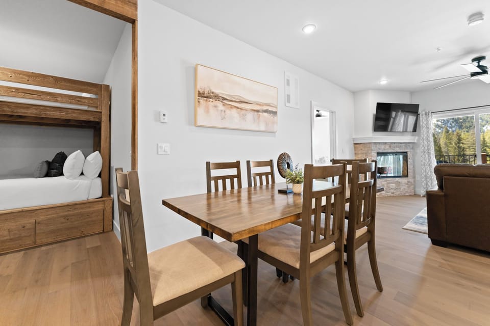 Step into your bright, spacious retreat where warm wood tones meet modern comfort—gather at the dining table, relax by the fireplace, and enjoy peaceful views through large windows.
