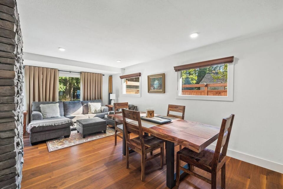Main dining table seats six (with two additional chairs available), centrally located between both living areas.