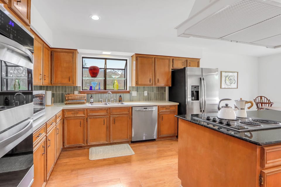 Your fully equipped kitchen awaits with granite counters, stainless appliances, and warm wood cabinets—perfect for preparing meals together.