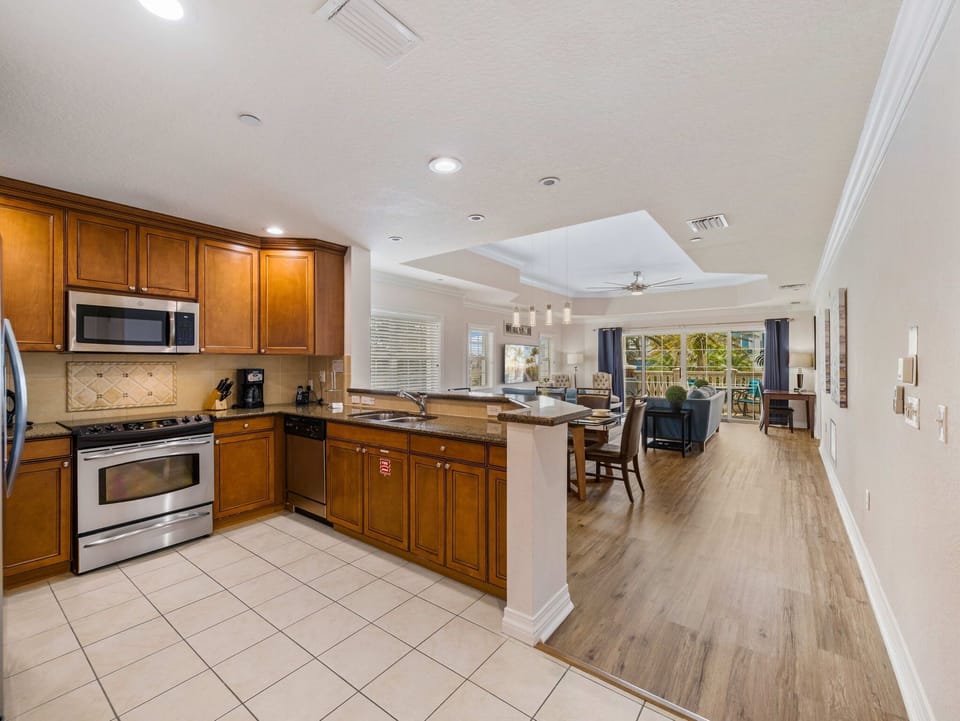A fully equipped kitchen with granite countertops and stainless appliances for easy vacation meals.