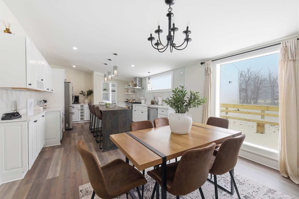 Dining for six beside the kitchen, with island seating just beyond.