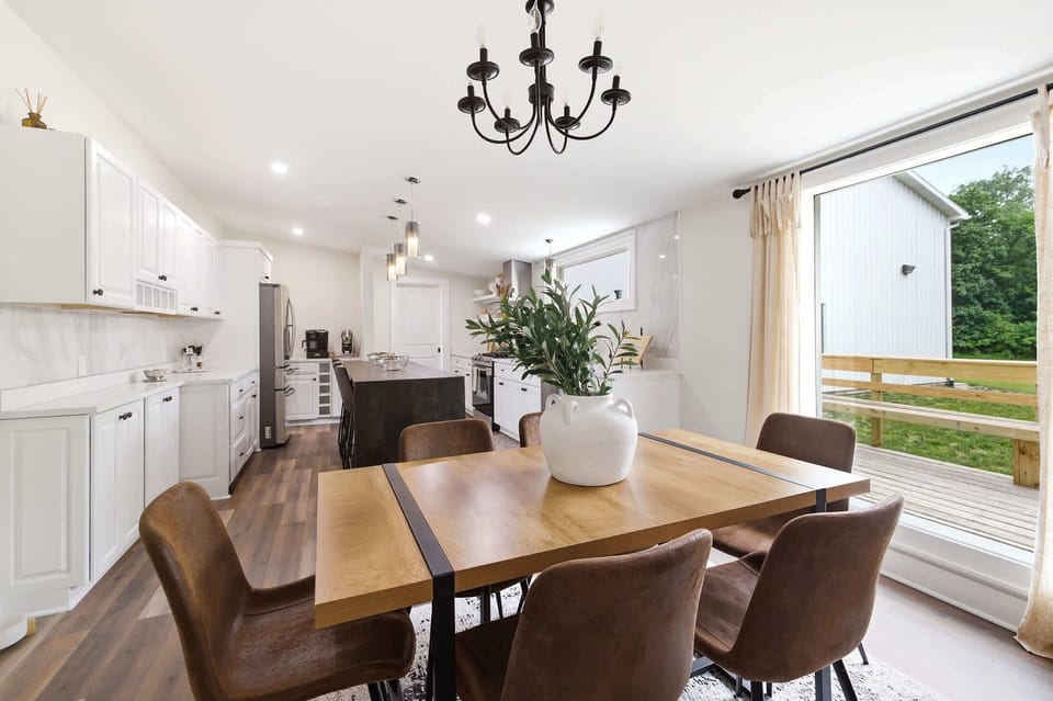 Dining for six beside the kitchen, with island seating just beyond.