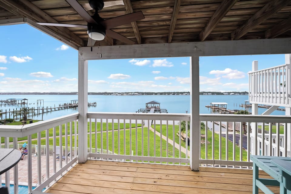 Covered lagoon-front balcony with ceiling fan and sweeping Little Lagoon views