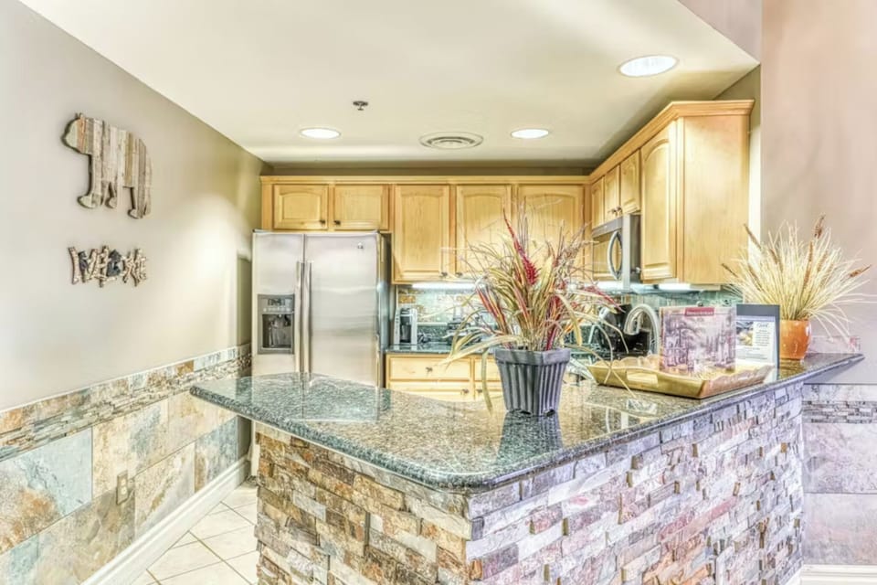 Your gourmet kitchen features granite countertops, stainless steel appliances, and a breakfast bar perfect for morning coffee or casual dining.