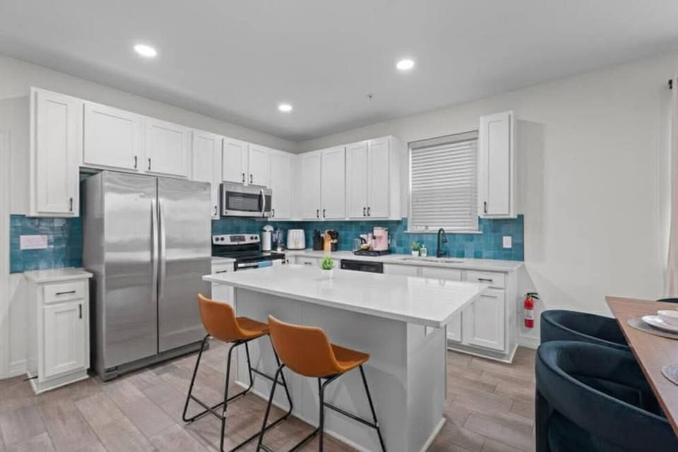 Chat with somone cooking while hanging out in this full kitchen.  Room for two to sit.