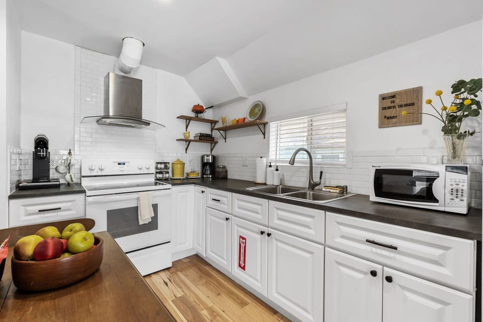 Cook your favorite meals in this bright, fully-equipped kitchen with modern appliances and ample counter space for meal prep.
