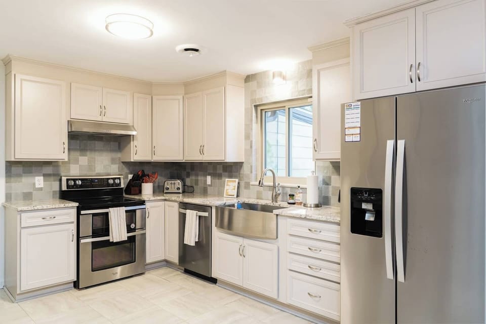 fully stocked kitchen with microwave, coffee maker, pots & pans, knives