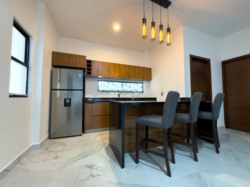 Modern kitchen with sleek island and ambient lighting
