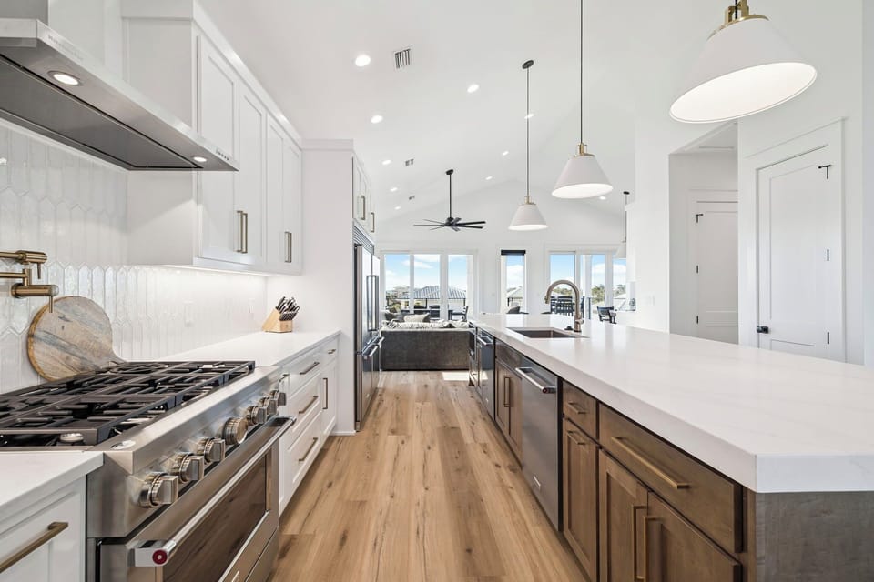 Cook gourmet meals in your stunning modern kitchen featuring premium appliances, spacious countertops, and elegant pendant lighting.