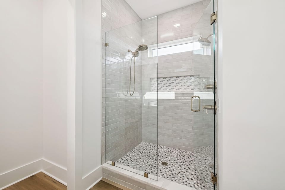 Step into your private spa with this stunning walk-in shower featuring elegant subway tiles and luxurious rainfall showerhead.