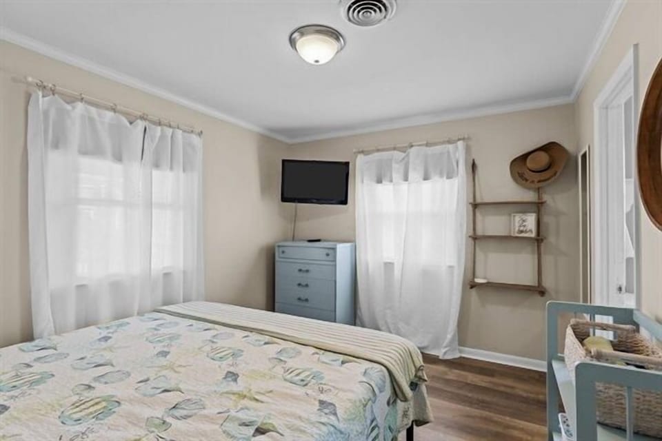 Your peaceful bedroom retreat features soft linens and coastal charm, creating the perfect space to unwind after your adventures.