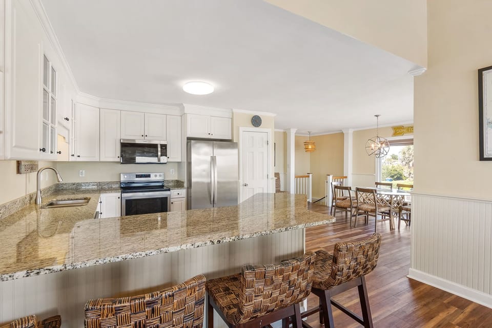 Your spacious kitchen features granite countertops, stainless steel appliances, and a breakfast bar where you can enjoy morning coffee.