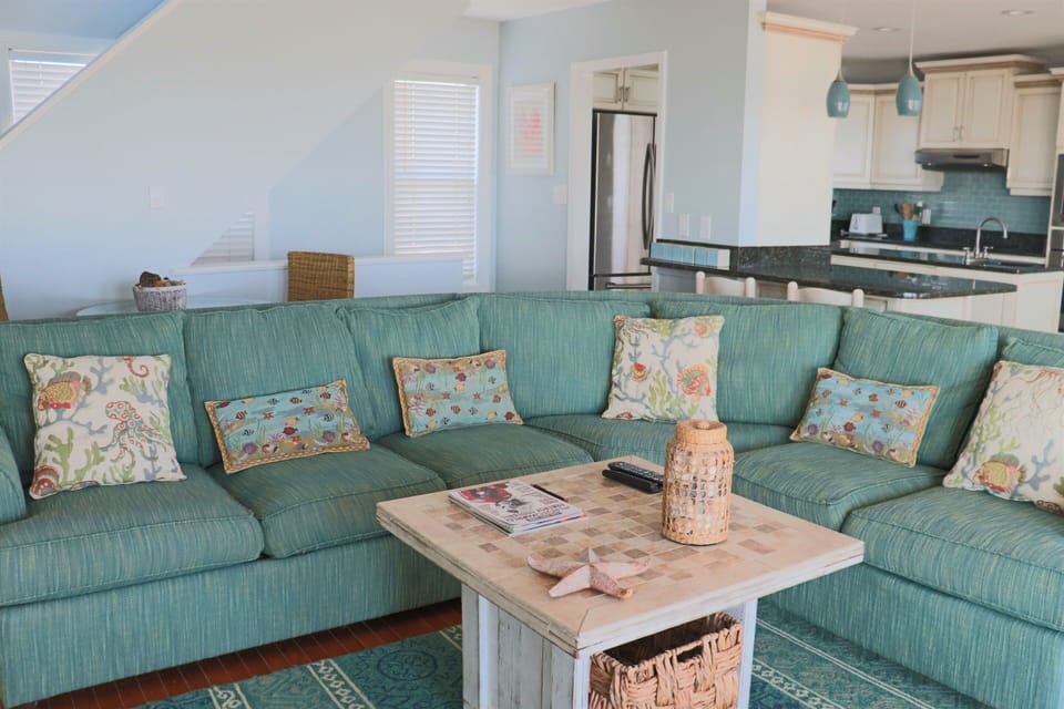 Sink into this spacious turquoise sectional where coastal charm meets comfort—your perfect spot for morning coffee or evening relaxation.