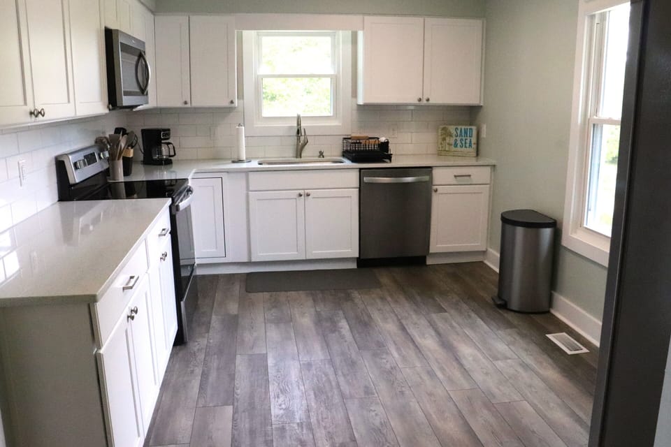 Your fully equipped kitchen makes meal prep a breeze with modern appliances, ample counter space, and sunny windows.