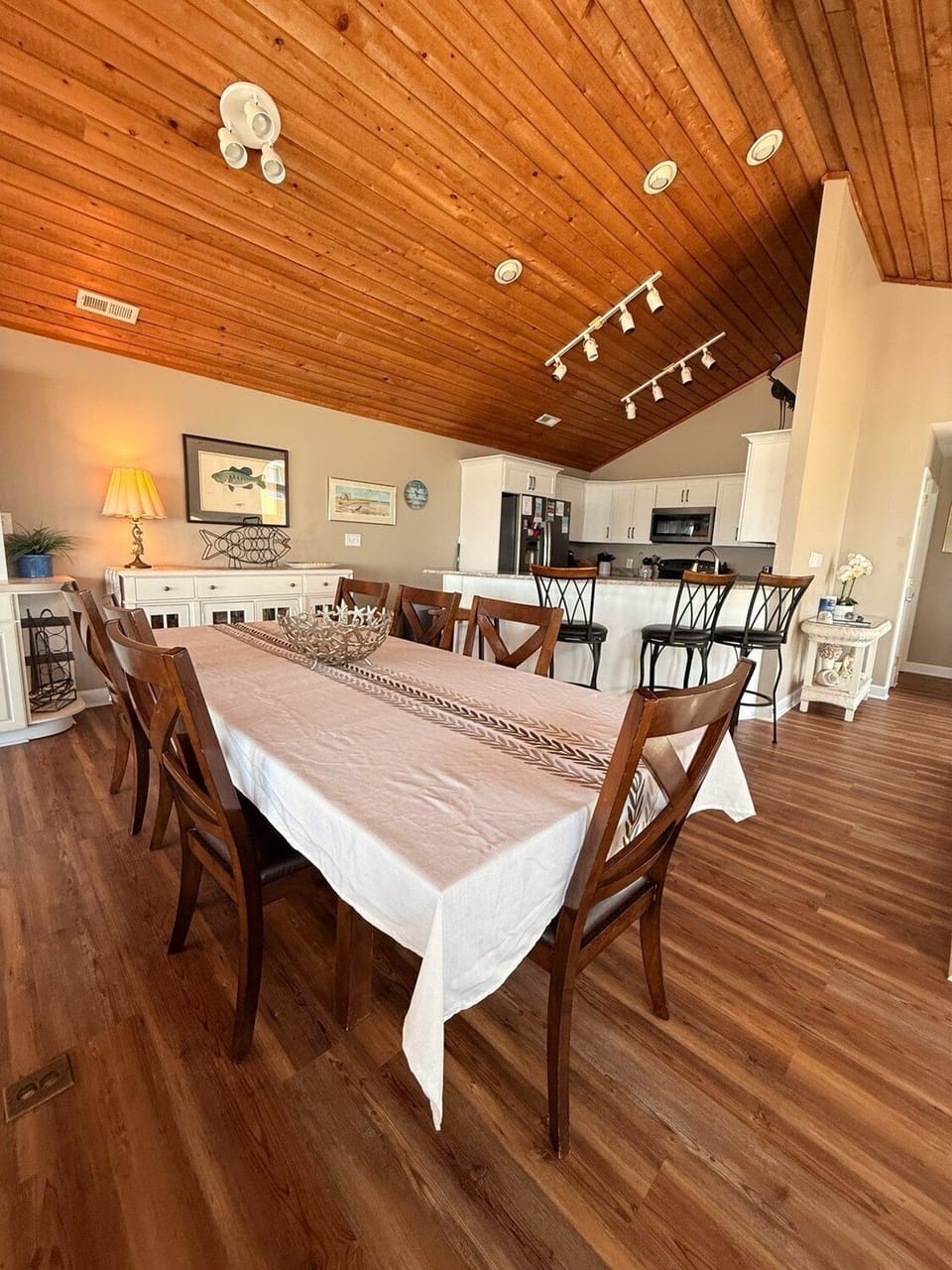 Gather around your spacious dining table under stunning vaulted wood ceilings, where everyone can share meals and make memories together in this warm, open-concept space.