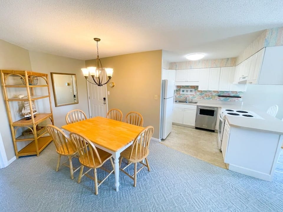 Dining and Kitchen- Dining area just off the kitchen, perfect for family meals and casual breakfasts.