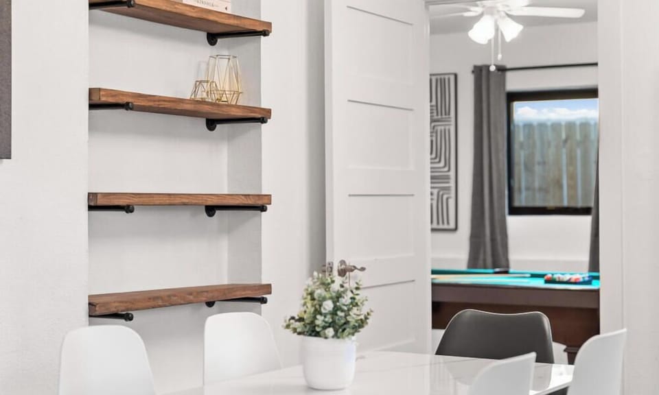 Floating wood shelves add a warm, modern touch.