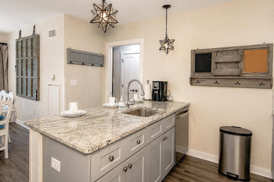 The kitchen features granite countertops, stainless steel appliances, and a spacious island.