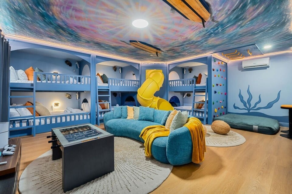The ultimate bunk room & play space! Featuring 6 queen-size bunk beds, this fun-filled room is perfect for kids, teens, and groups to sleep, play, and make unforgettable memories together.