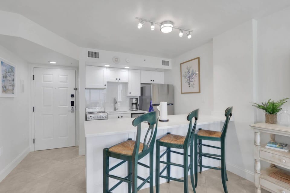 The kitchen is defined by a spacious island with barstool seating - doubling the typical counter and storage space in many of the resort's units.