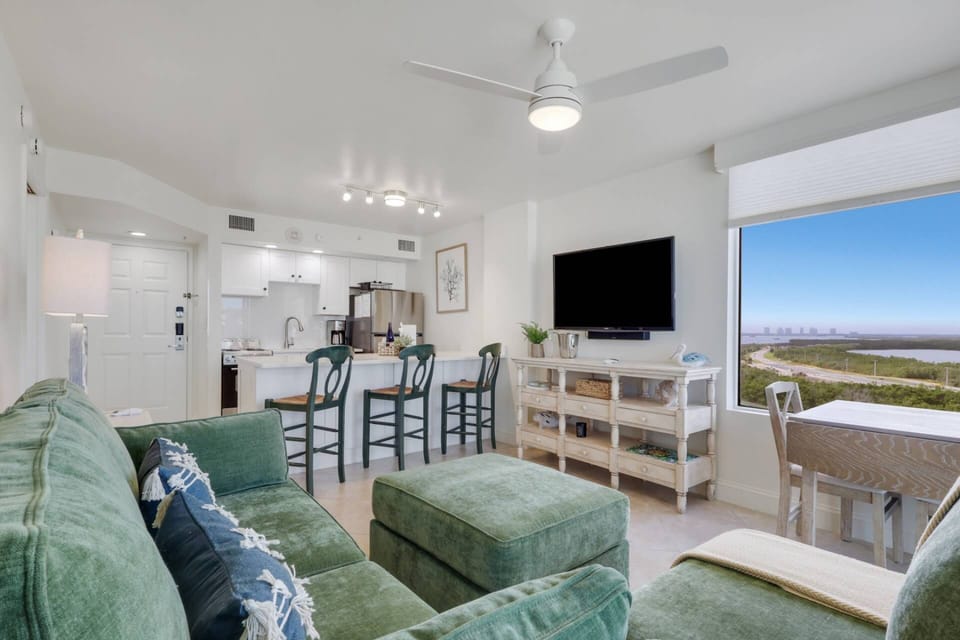 The main living space includes living, dining and kitchen in an open, flowing floorplan & custom window treatments