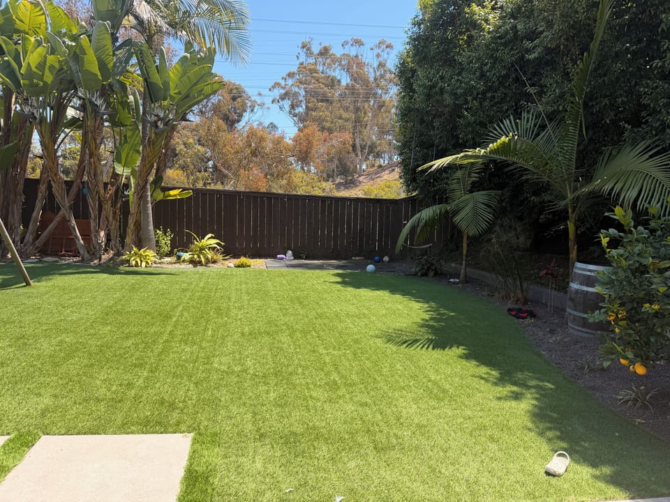 Spacious backyard with 12ft trampoline to the right of image