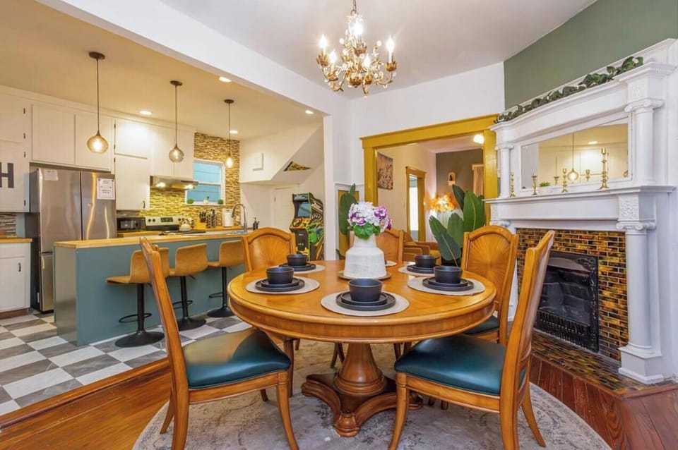 Beneath the warm glow of a chandelier, this space sets the stage for cozy dining