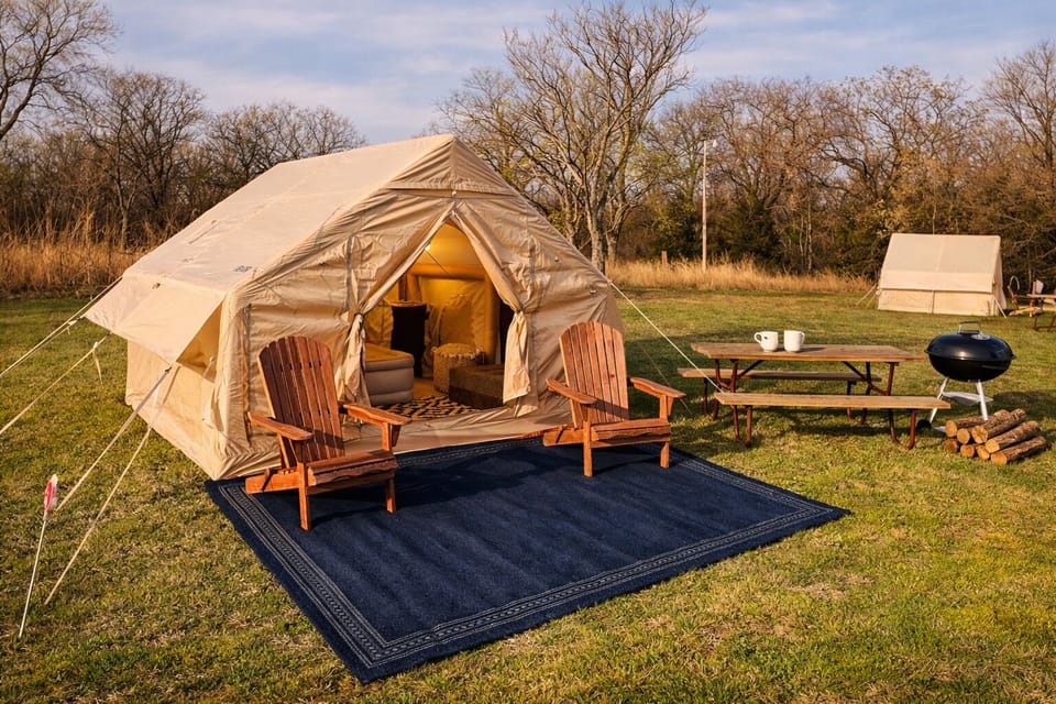 Private glamping setup with outdoor seating, BBQ grill, and picnic area.