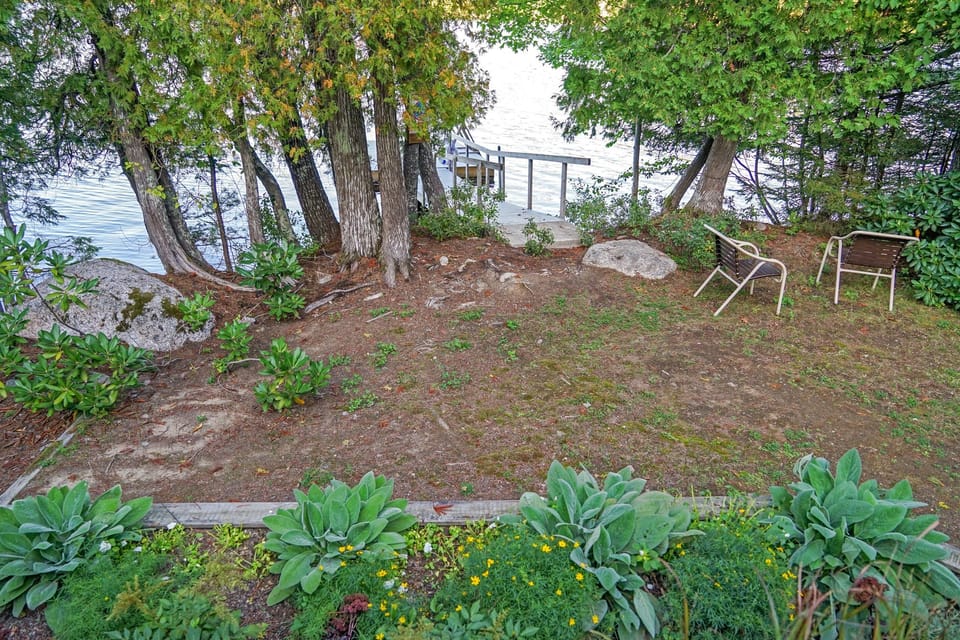 Our natural backyard offers a direct path to the water’s edge. This rugged, wooded space is designed for low-maintenance lake living, providing a quiet spot to watch the loons or head down to the private dock on Long Pond.