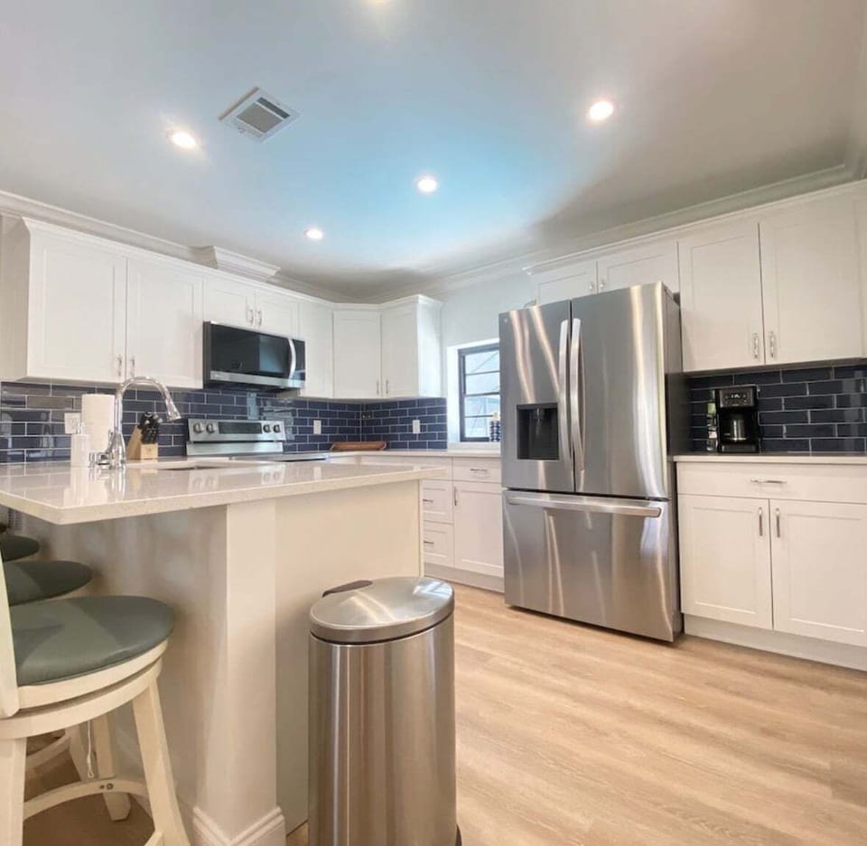 Modern Design: Featuring crisp white cabinetry and quartz countertops