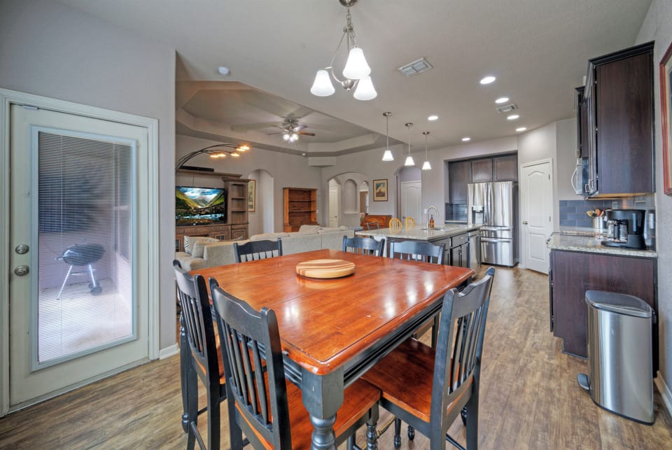 Bright dining room with views of the backyard and open-plan kitchen access.