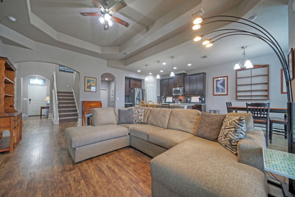 Expansive family room with a large sectional sofa and recessed lighting.
