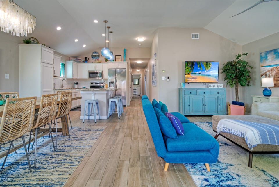 Spacious open-concept layout connecting the living room, dining area, and fully equipped kitchen.