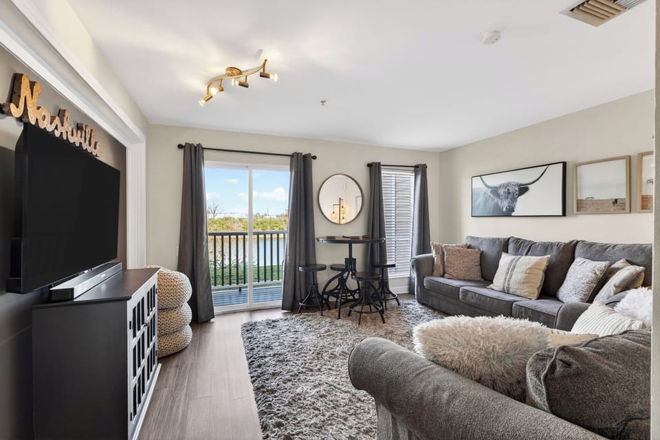 Open-concept layout featuring a cozy rug and easy access to outdoor views.