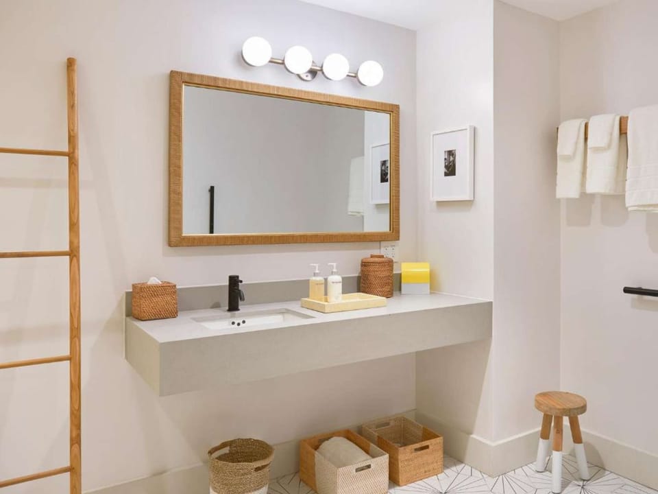 Sink vanity with woven baskets and wall ladder