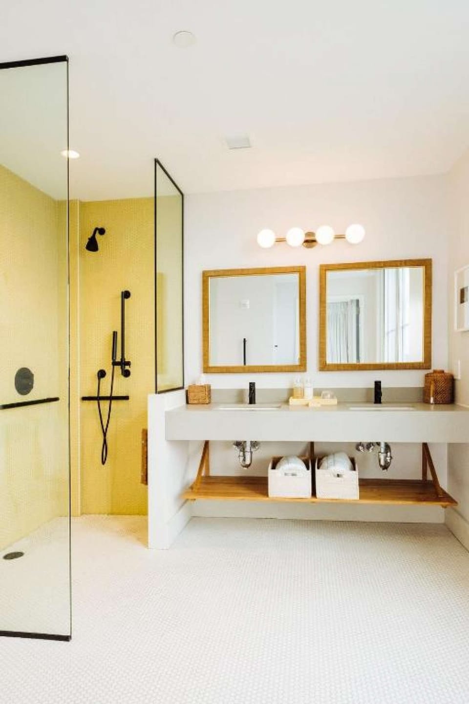 Double vanity with wood mirrors and walk in shower.