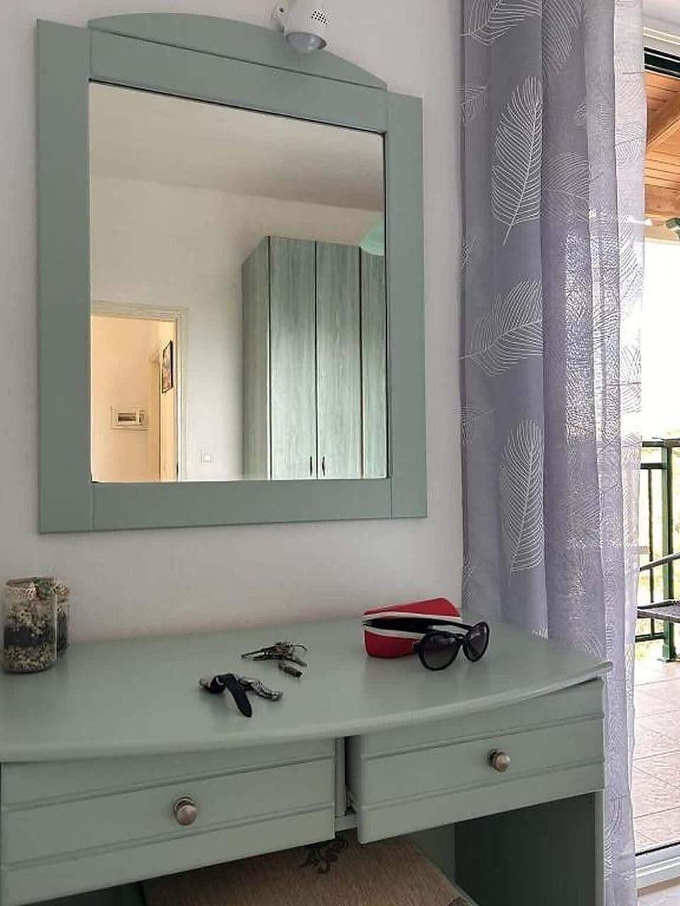 Mirror and dresser inside the bedroom.