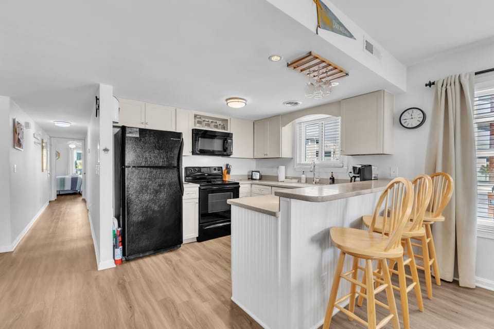 Your fully-equipped kitchen features modern appliances and a breakfast bar where you can sip morning coffee while planning your day.