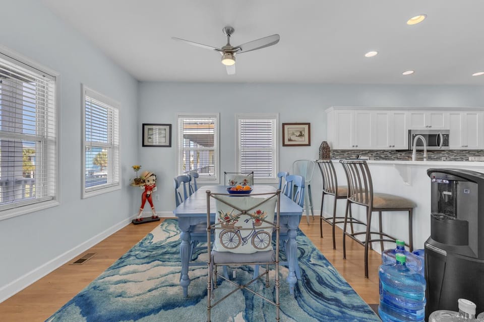 Your bright dining space flows seamlessly into the modern kitchen, where morning coffee and evening meals become memorable moments together.
