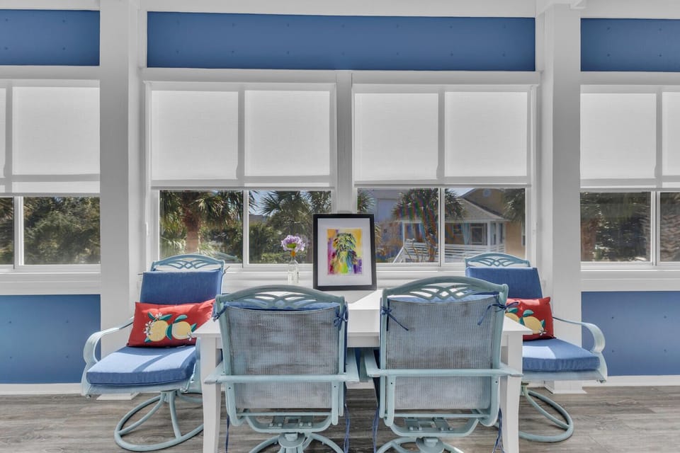 Relax in your bright sunroom where colorful chairs invite morning coffee moments and afternoon reading sessions.