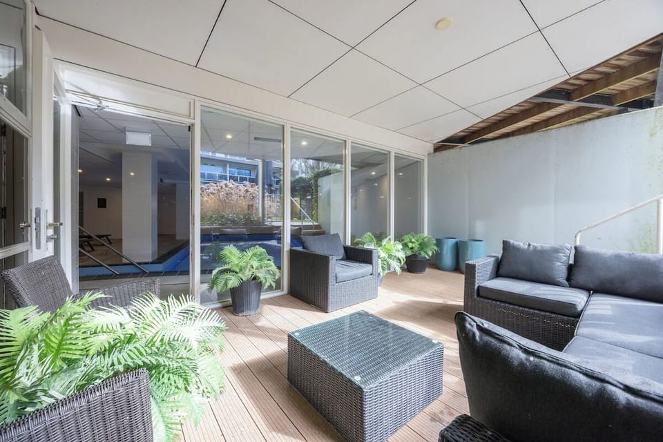 Lounge outdoors on the patio with fresh air and greenery.