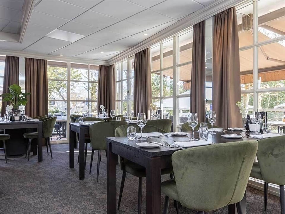 Dine in a sunlit room with serene garden views.
