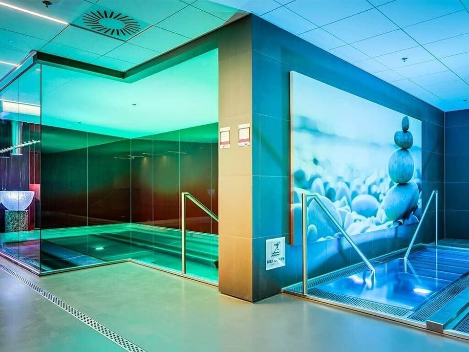 Unwind in soothing spa pools under calming ambient light.