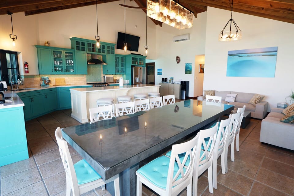 The oversized kitchen has a 12 person dining table and extra seating at the island as well as a sitting area